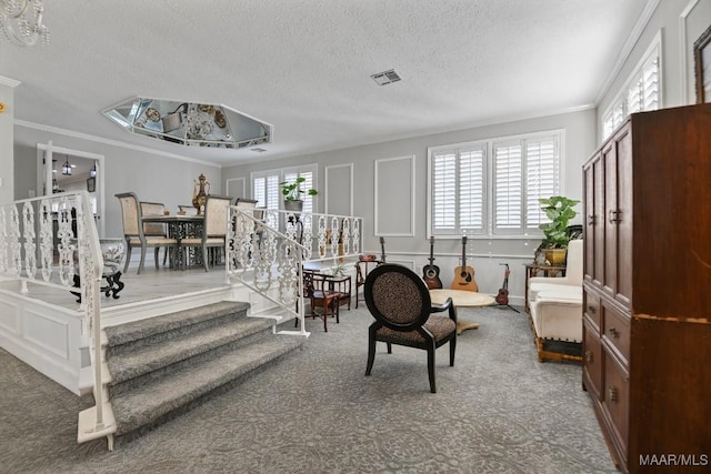 living room featuring ornamental molding and a textured ceiling