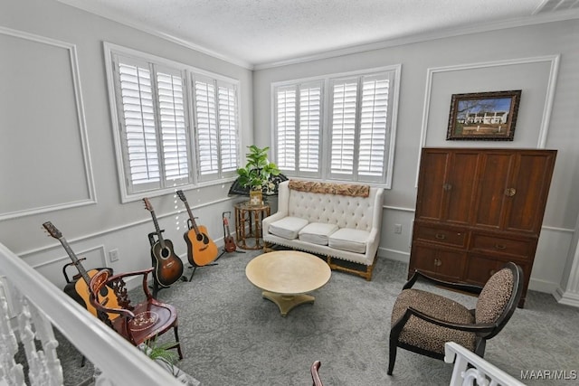 sitting room with a textured ceiling, light colored carpet, and crown molding