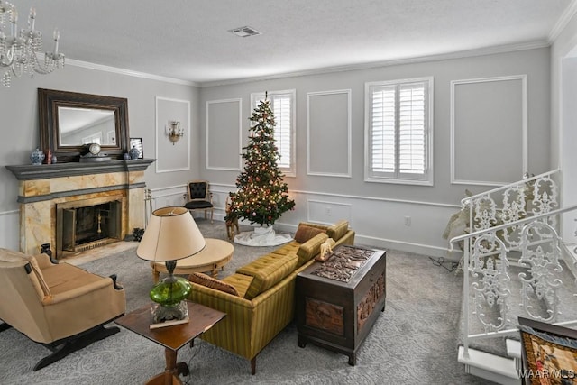 living room with light carpet, a high end fireplace, ornamental molding, a textured ceiling, and a notable chandelier