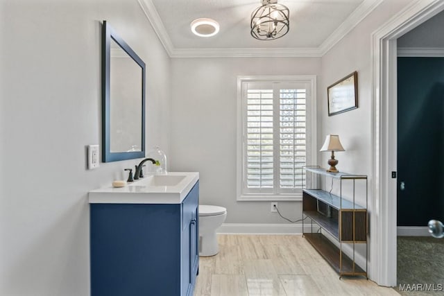 bathroom featuring vanity, toilet, and ornamental molding