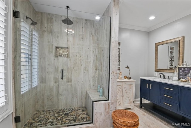 bathroom with an enclosed shower, wood-type flooring, vanity, and a wealth of natural light