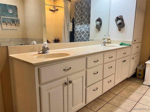 bathroom with tile patterned flooring and vanity