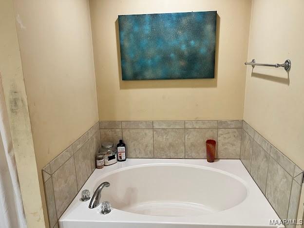 bathroom with a tub to relax in