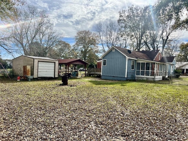 view of yard featuring an outbuilding, a garage, and a carport