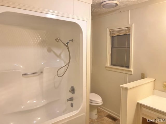 full bathroom with shower / bathing tub combination, vanity, a textured ceiling, and toilet