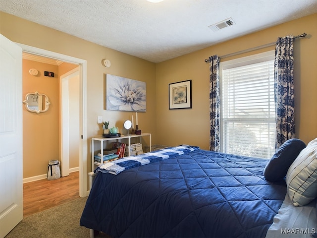 carpeted bedroom with a textured ceiling