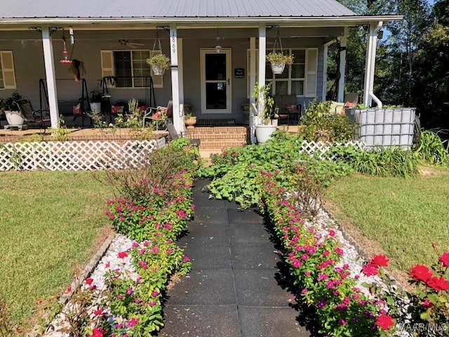 view of exterior entry featuring a lawn