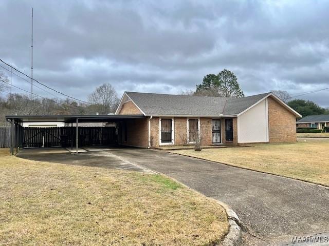 single story home with a front lawn and a carport