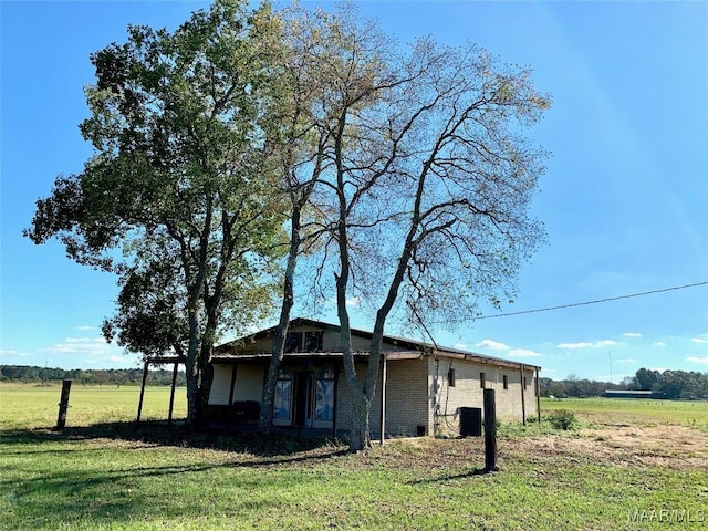 view of property exterior featuring a lawn and central AC unit