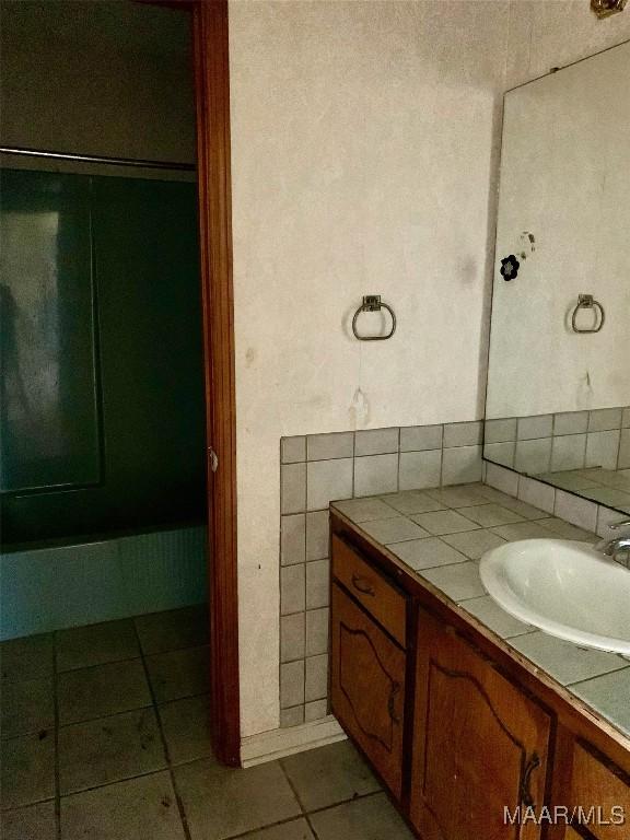 bathroom with tile patterned flooring and vanity