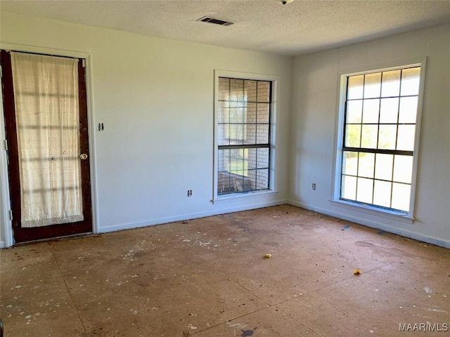 empty room with a textured ceiling