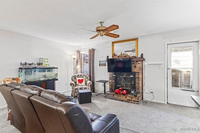 living room featuring carpet flooring, ceiling fan, a textured ceiling, and a brick fireplace