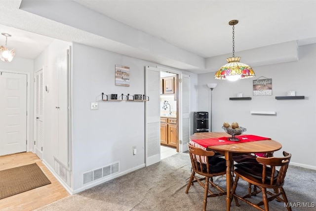 dining area with sink and carpet