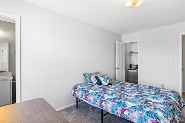 bedroom featuring carpet flooring and a textured ceiling