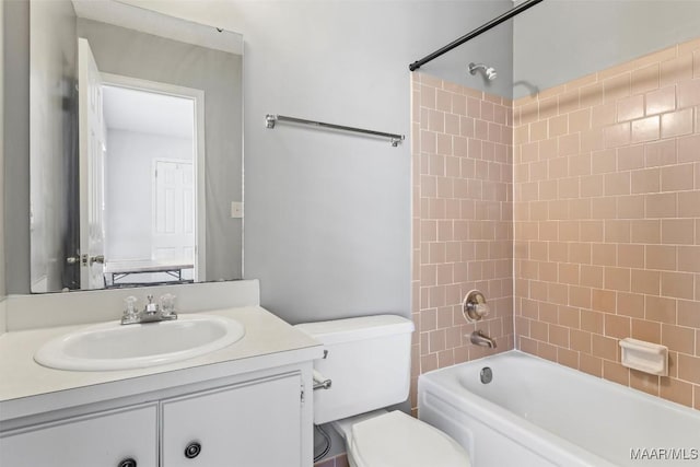 full bathroom featuring vanity, toilet, and tiled shower / bath