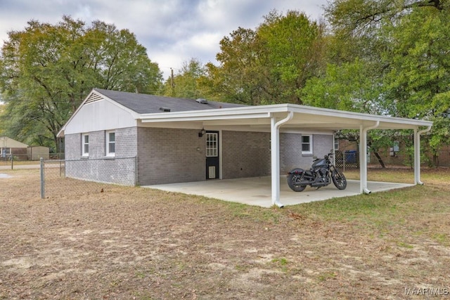 back of property with a carport