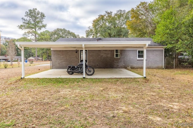 back of house with a yard and a carport