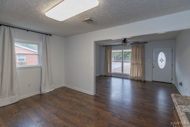 entryway featuring a textured ceiling, dark hardwood / wood-style floors, and ceiling fan