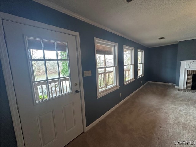 doorway to outside with carpet flooring, ornamental molding, a fireplace, and a textured ceiling