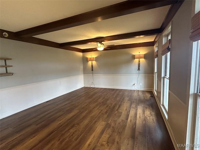 unfurnished room with beam ceiling, dark hardwood / wood-style floors, and ceiling fan