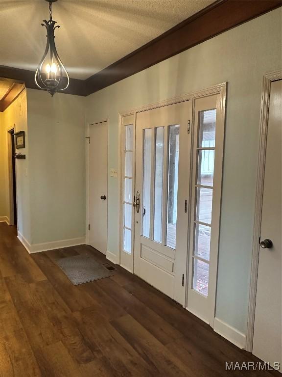 entryway with a textured ceiling and dark hardwood / wood-style floors