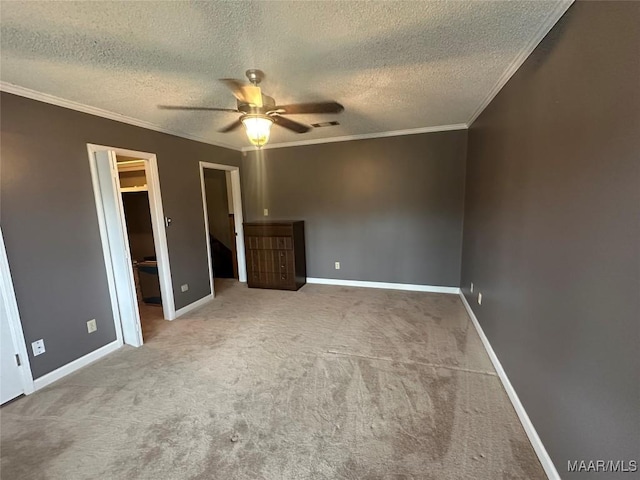 unfurnished bedroom featuring ceiling fan, crown molding, carpet floors, and a textured ceiling