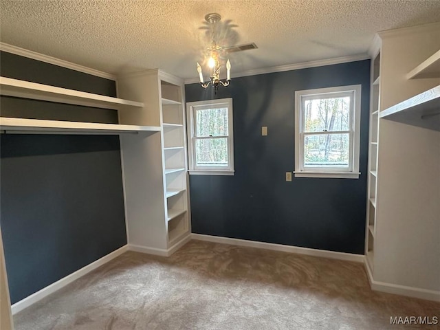 spacious closet with carpet and a notable chandelier