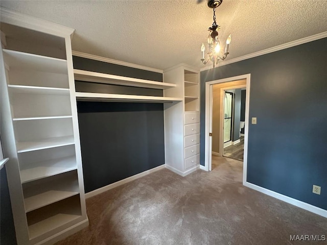 spacious closet with dark colored carpet and an inviting chandelier