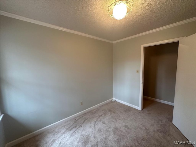 carpeted spare room with a textured ceiling and ornamental molding