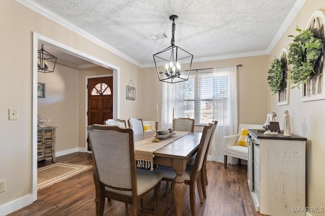 dining area featuring a textured ceiling, dark hardwood / wood-style flooring, crown molding, and a chandelier