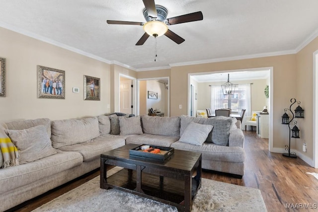 living room featuring a textured ceiling, ornamental molding, ceiling fan with notable chandelier, and hardwood / wood-style flooring