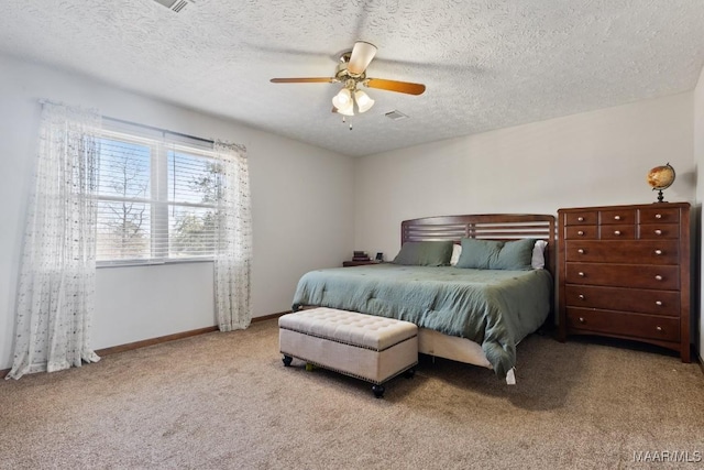 bedroom featuring light carpet, ceiling fan, and a textured ceiling