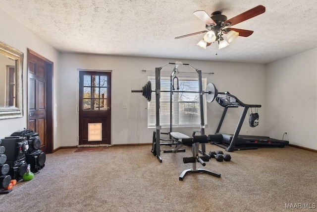 exercise area featuring carpet floors, ceiling fan, and a textured ceiling