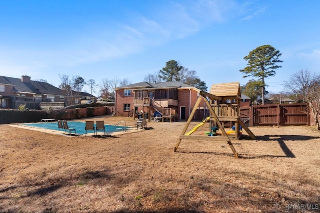 view of jungle gym featuring a fenced in pool