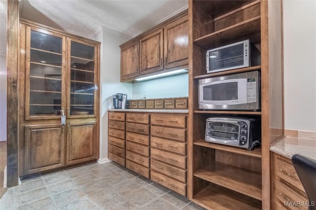 kitchen featuring a textured ceiling and built in microwave