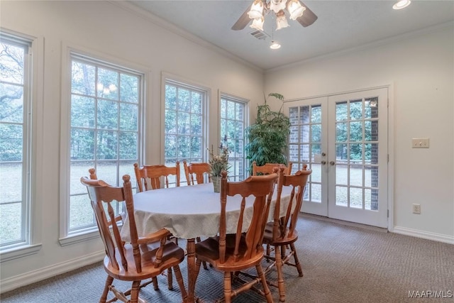 carpeted dining room with ceiling fan, ornamental molding, and french doors