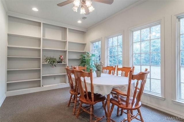 dining space featuring carpet floors, a wealth of natural light, crown molding, and ceiling fan