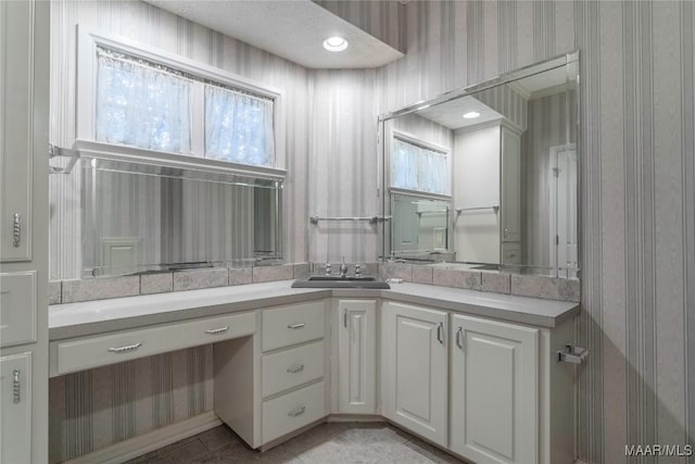 bathroom with tile patterned floors and vanity