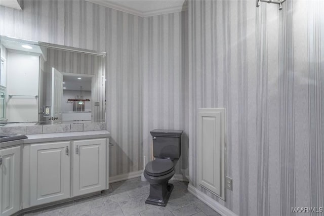 bathroom featuring vanity, ornamental molding, and toilet