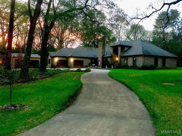 view of front of home featuring a garage and a lawn