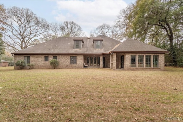 back of house with a lawn