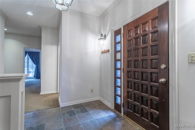 carpeted foyer with crown molding