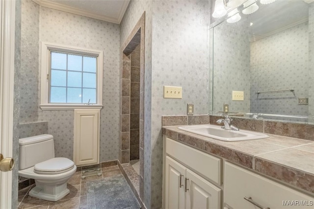 bathroom with vanity, toilet, walk in shower, and crown molding