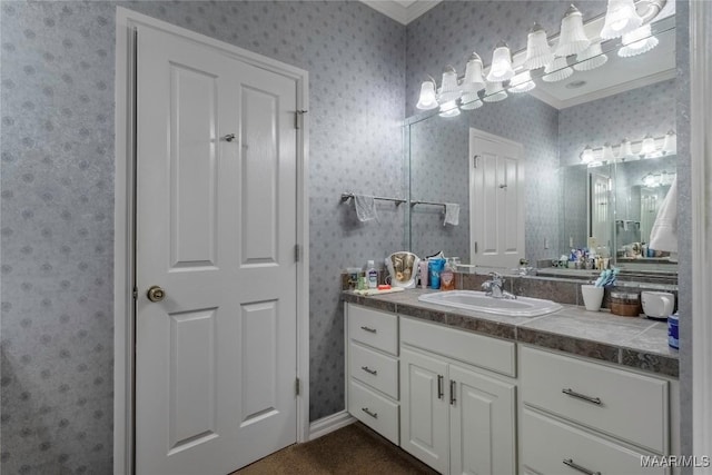 bathroom featuring crown molding and vanity