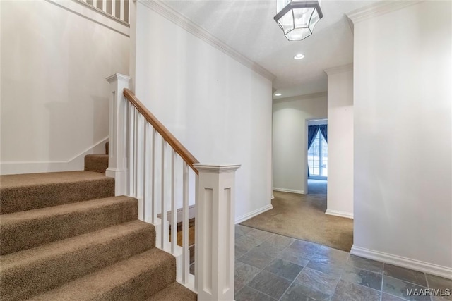 stairs with carpet floors and crown molding