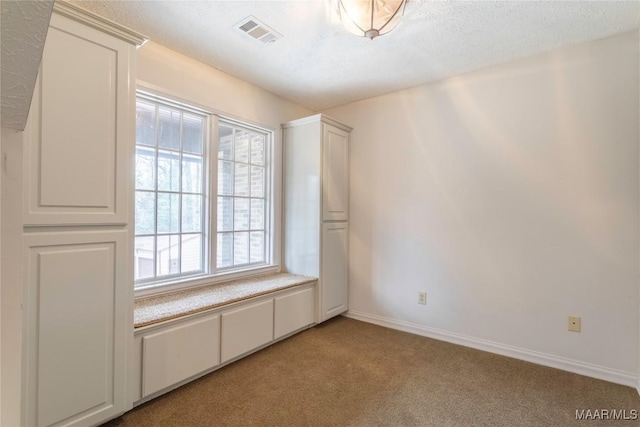 spare room featuring light colored carpet