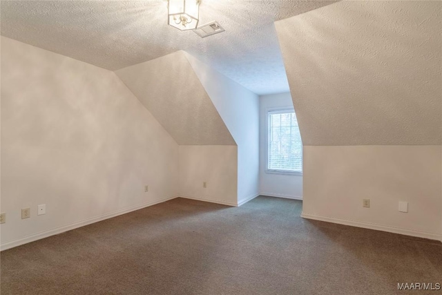 bonus room with a textured ceiling, carpet floors, and lofted ceiling