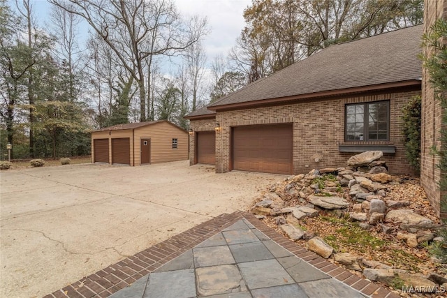 view of side of property with a garage and an outdoor structure