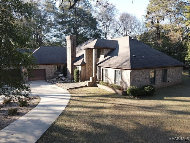 view of front of property with a garage and a front yard