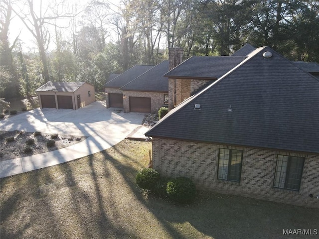 view of home's exterior featuring an outdoor structure and a garage